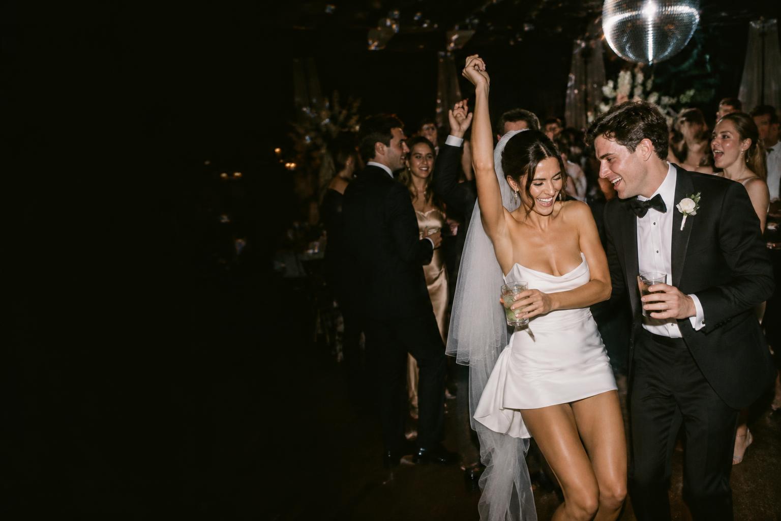 Newlyweds laughing on their wedding dance floor